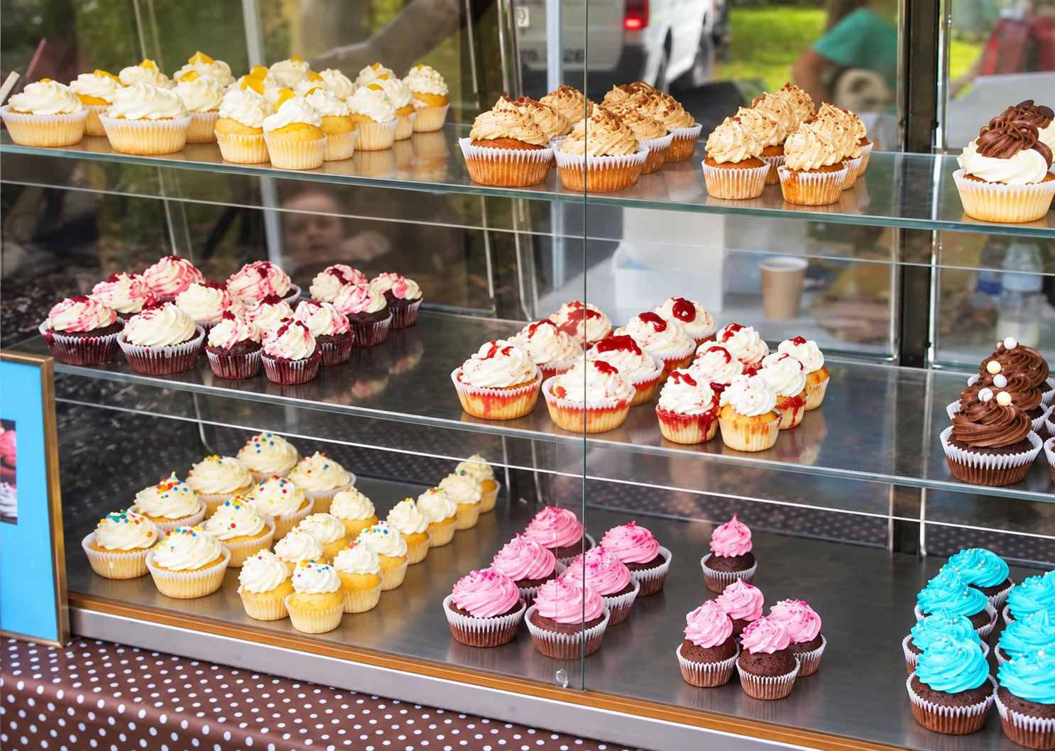 Decorated cupcakes in a display cabinet