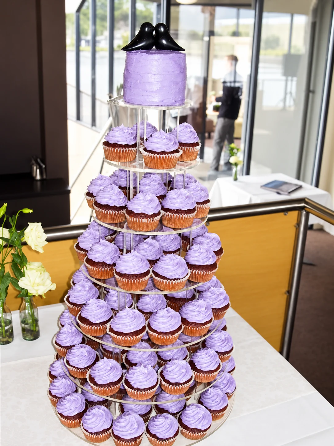 Tiered purple and white wedding cupcake tower