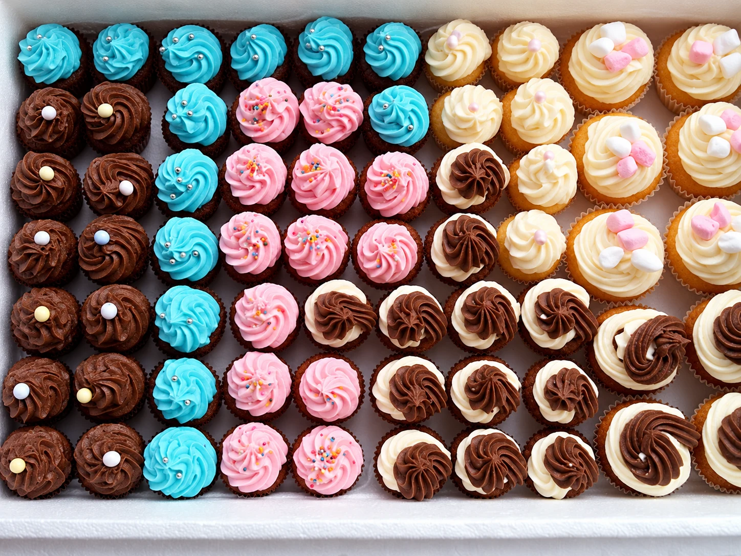A display of assorted decorated cupcakes
