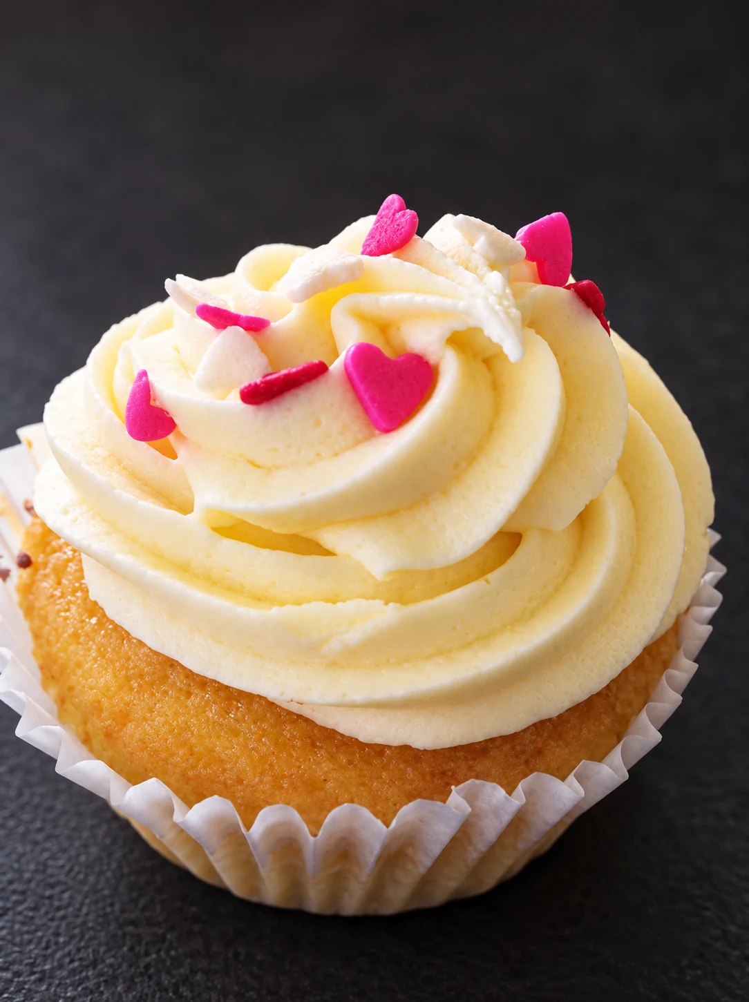 Vanilla cupcake with tiny pink hearts